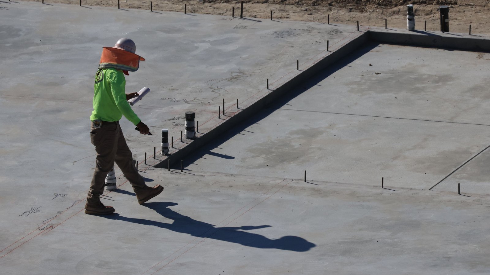 Site engineer inspecting completed construction work for quality and compliance.